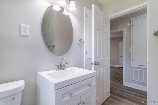 3468 Biltmore Ave, Montgomery, AL 36109 - half bath featuring wood finished floors, vanity, toilet, and baseboards
