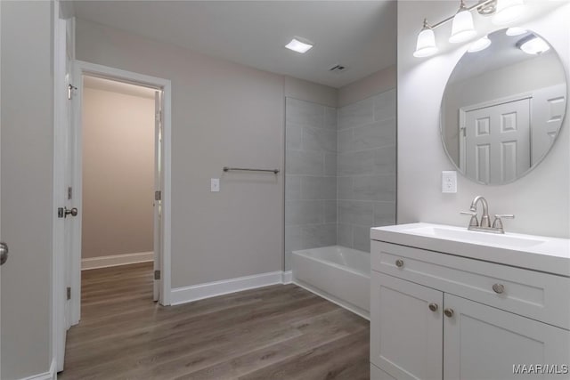 3468 Biltmore Ave, Montgomery, AL 36109 - full bath with wood finished floors, vanity, baseboards, and washtub / shower combination