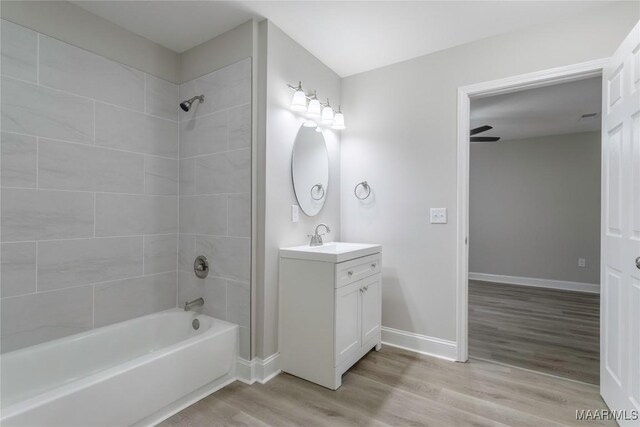 3468 Biltmore Ave, Montgomery, AL 36109 - bathroom with shower / bathtub combination, vanity, wood finished floors, and baseboards