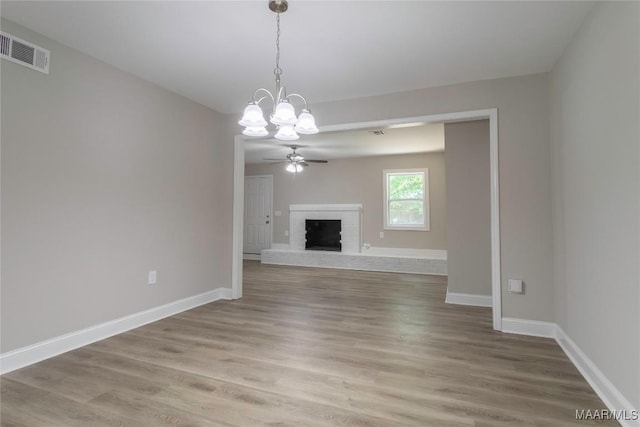 3468 Biltmore Ave, Montgomery, AL 36109 - unfurnished living room featuring a chandelier, light wood finished floors, baseboards, and a fireplace