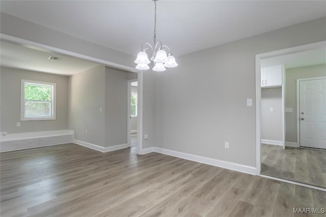 3468 Biltmore Ave, Montgomery, AL 36109 - empty room with light wood finished floors, a chandelier, and baseboards
