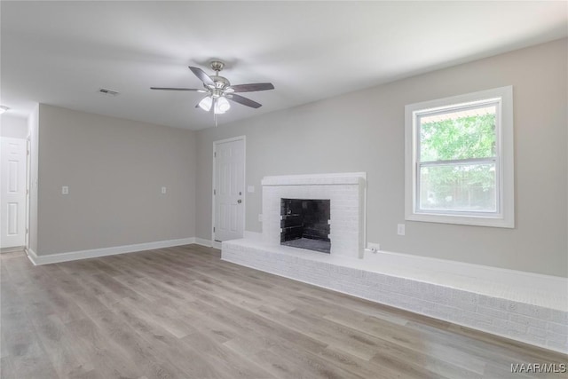3468 Biltmore Ave, Montgomery, AL 36109 - unfurnished living room with wood finished floors, a ceiling fan, a brick fireplace, and baseboards