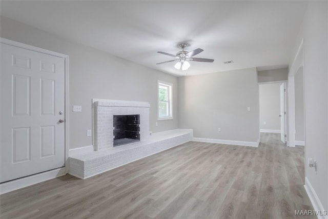 3468 Biltmore Ave, Montgomery, AL 36109 - unfurnished living room with light wood-style flooring, ceiling fan, a brick fireplace, and baseboards