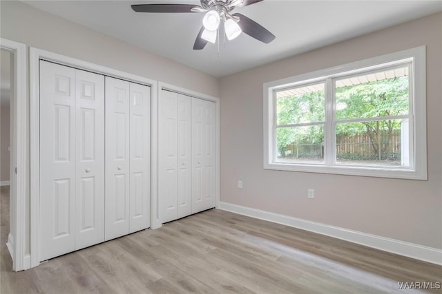 3468 Biltmore Ave, Montgomery, AL 36109 - unfurnished bedroom featuring two closets, baseboards, light wood-style flooring, and ceiling fan