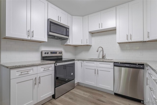 3468 Biltmore Ave, Montgomery, AL 36109 - kitchen with appliances with stainless steel finishes, a sink, white cabinetry, and light wood-style flooring