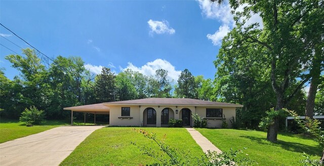 4438 Eley Ct, Montgomery, AL 36106 - ranch-style home with stucco siding, driveway, a front lawn, and a carport