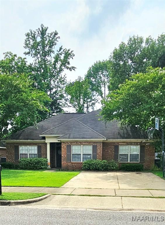 6200 Sycamore Dr, Montgomery, AL 36117 - view of front of property with brick siding, a front lawn, and concrete driveway