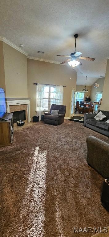 6200 Sycamore Dr, Montgomery, AL 36117 - carpeted living room featuring a ceiling fan, plenty of natural light, a textured ceiling, crown molding, and a tile fireplace