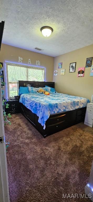 6200 Sycamore Dr, Montgomery, AL 36117 - carpeted bedroom with a textured ceiling