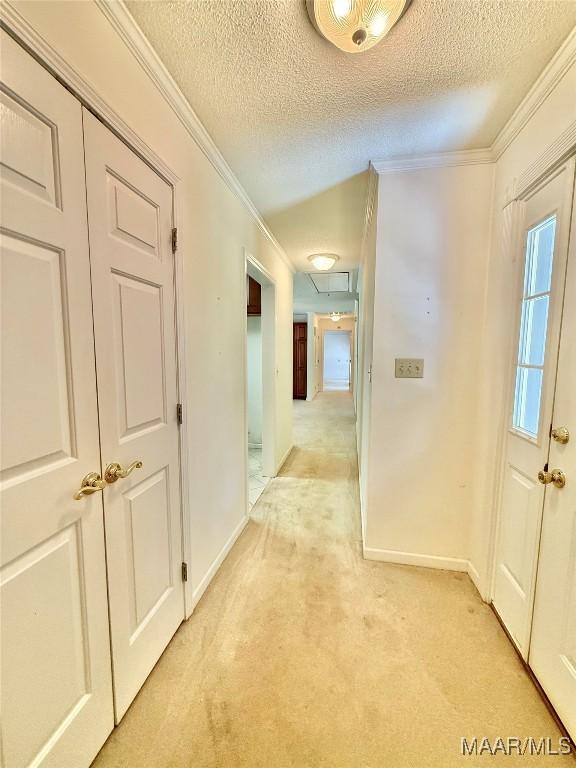 441 County Road 401, Selma, AL 36701 - corridor with ornamental molding, a textured ceiling, baseboards, light carpet, and attic access