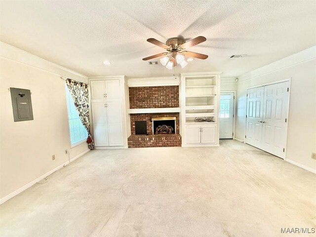 441 County Road 401, Selma, AL 36701 - unfurnished living room featuring electric panel, a ceiling fan, a fireplace, a textured ceiling, and light colored carpet