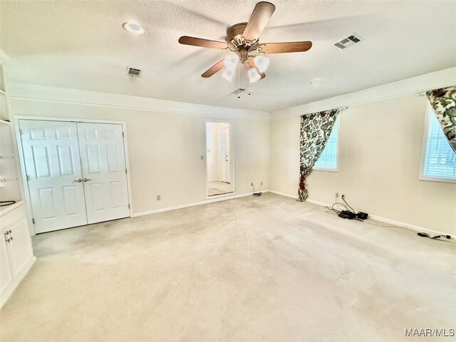 441 County Road 401, Selma, AL 36701 - unfurnished bedroom featuring light carpet, baseboards, a textured ceiling, ceiling fan, and a closet