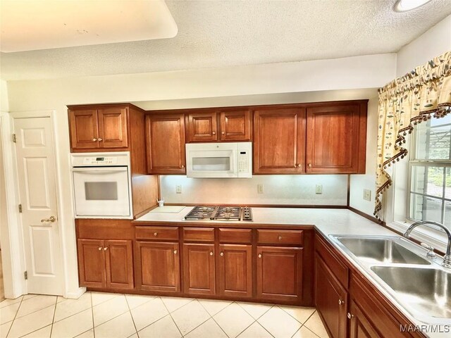 441 County Road 401, Selma, AL 36701 - kitchen featuring white appliances, a sink, light tile patterned floors, light countertops, and a textured ceiling