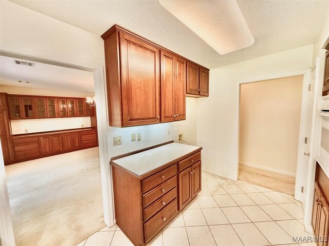 441 County Road 401, Selma, AL 36701 - kitchen featuring light carpet, brown cabinets, a textured ceiling, and light countertops