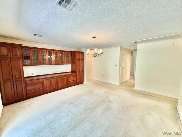 441 County Road 401, Selma, AL 36701 - unfurnished living room featuring attic access, light carpet, a textured ceiling, baseboards, and a chandelier