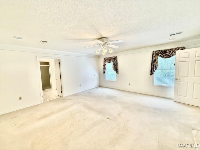 441 County Road 401, Selma, AL 36701 - spare room with light colored carpet, ceiling fan, healthy amount of natural light, baseboards, and a textured ceiling