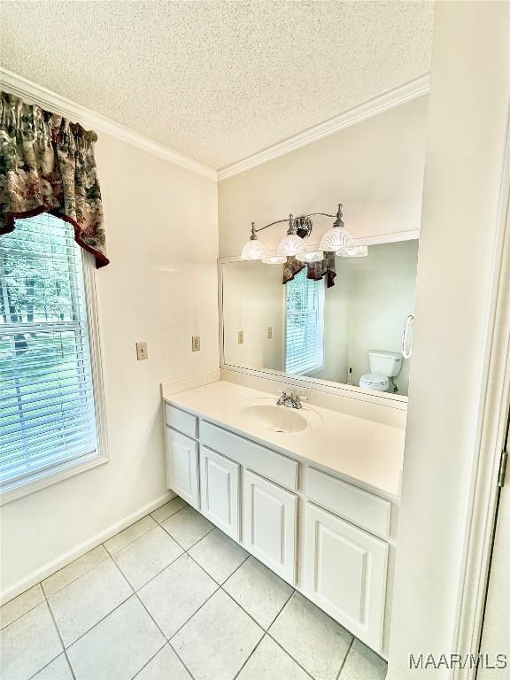 441 County Road 401, Selma, AL 36701 - bathroom with a textured ceiling, vanity, crown molding, tile patterned floors, and baseboards