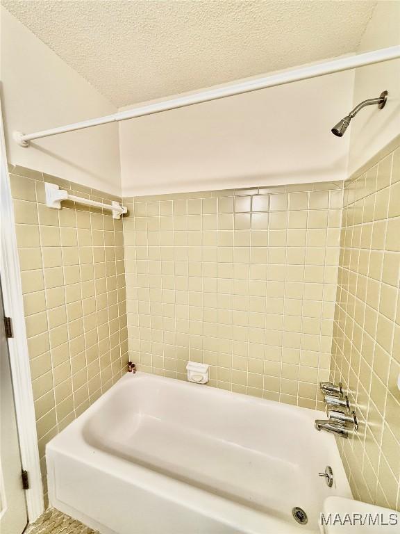 441 County Road 401, Selma, AL 36701 - bathroom featuring tile walls, a textured ceiling, and  shower combination