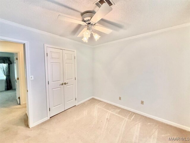 441 County Road 401, Selma, AL 36701 - unfurnished bedroom with light carpet, a textured ceiling, ornamental molding, baseboards, and a closet
