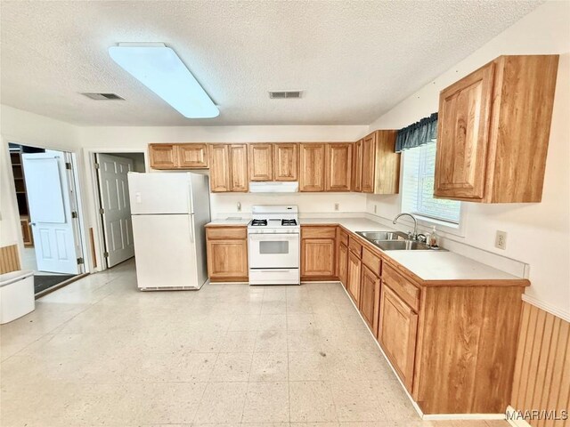 441 County Road 401, Selma, AL 36701 - kitchen with white appliances, a sink, range hood, a textured ceiling, and light countertops