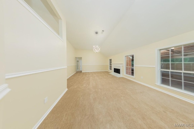 929 Ironwood Dr, Montgomery, AL 36117 - unfurnished living room featuring vaulted ceiling, a fireplace with flush hearth, baseboards, and carpet