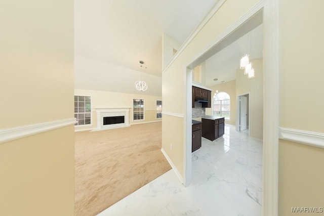 929 Ironwood Dr, Montgomery, AL 36117 - unfurnished living room featuring a fireplace, light marble finish floors, light colored carpet, baseboards, and a chandelier