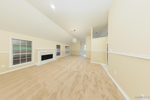 929 Ironwood Dr, Montgomery, AL 36117 - unfurnished living room with lofted ceiling, light carpet, a fireplace, and baseboards