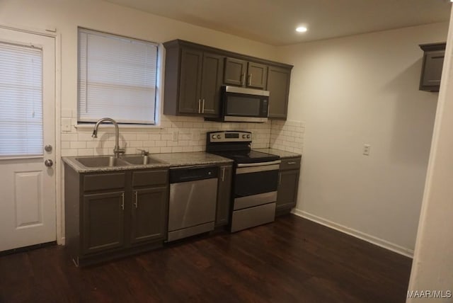 1324-1326 Federal Dr, Montgomery, AL 36107 - kitchen with appliances with stainless steel finishes, a sink, backsplash, dark wood-style floors, and baseboards