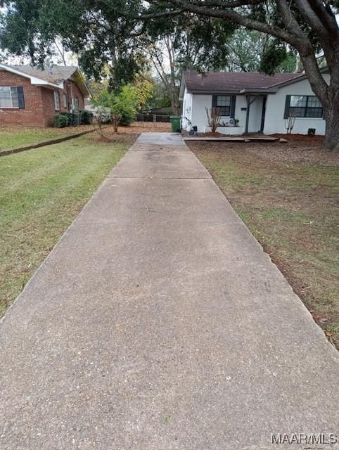 1324-1326 Federal Dr, Montgomery, AL 36107 - view of front facade featuring concrete driveway and a front lawn