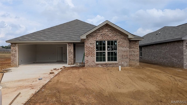 2043 Dawsons Mill Loop, Prattville, AL 36067 - view of front facade with concrete driveway, brick siding, an attached garage, and roof with shingles