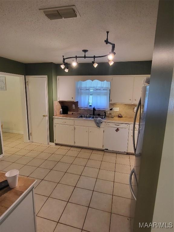 480 Avon Rd, Montgomery, AL 36109 - kitchen featuring dishwasher, white cabinets, a sink, light countertops, and light tile patterned flooring