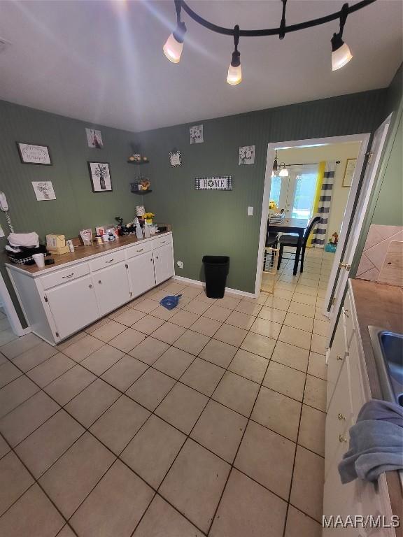 480 Avon Rd, Montgomery, AL 36109 - kitchen featuring white cabinets, light tile patterned floors, light countertops, and baseboards