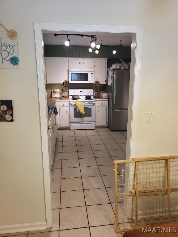 480 Avon Rd, Montgomery, AL 36109 - kitchen featuring white appliances, light tile patterned floors, white cabinets, and light countertops