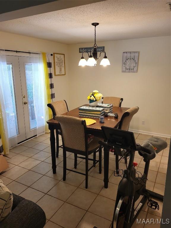 480 Avon Rd, Montgomery, AL 36109 - dining space featuring light tile patterned floors, a chandelier, and a textured ceiling