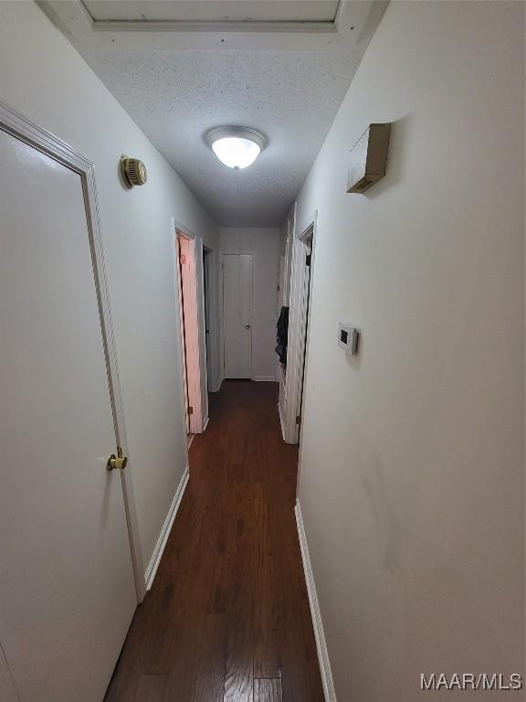 480 Avon Rd, Montgomery, AL 36109 - hall with dark wood-style flooring, baseboards, and a textured ceiling