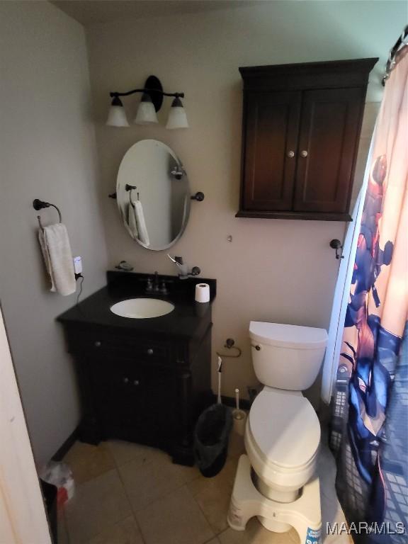 480 Avon Rd, Montgomery, AL 36109 - bathroom with vanity, tile patterned flooring, toilet, and curtained shower