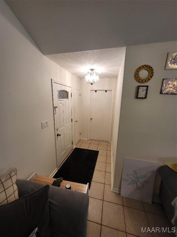 480 Avon Rd, Montgomery, AL 36109 - entryway featuring light tile patterned floors, a chandelier, and a textured ceiling