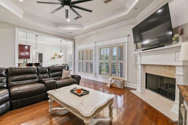 541 Jasmine Trl, Prattville, AL 36066 - living area with a tray ceiling, ceiling fan, crown molding, a high end fireplace, and hardwood / wood-style floors