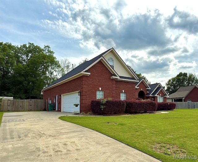 40 Larkspur Ln, Millbrook, AL 36054 - view of side of home with concrete driveway, brick siding, and an attached garage