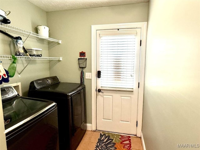 40 Larkspur Ln, Millbrook, AL 36054 - laundry area with washing machine and clothes dryer, light tile patterned flooring, and baseboards
