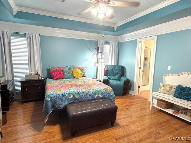 40 Larkspur Ln, Millbrook, AL 36054 - bedroom with wood finished floors, ornamental molding, ceiling fan, baseboards, and a tray ceiling