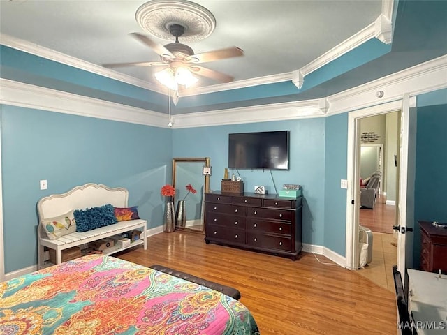 40 Larkspur Ln, Millbrook, AL 36054 - bedroom featuring crown molding, wood finished floors, a tray ceiling, baseboards, and a ceiling fan