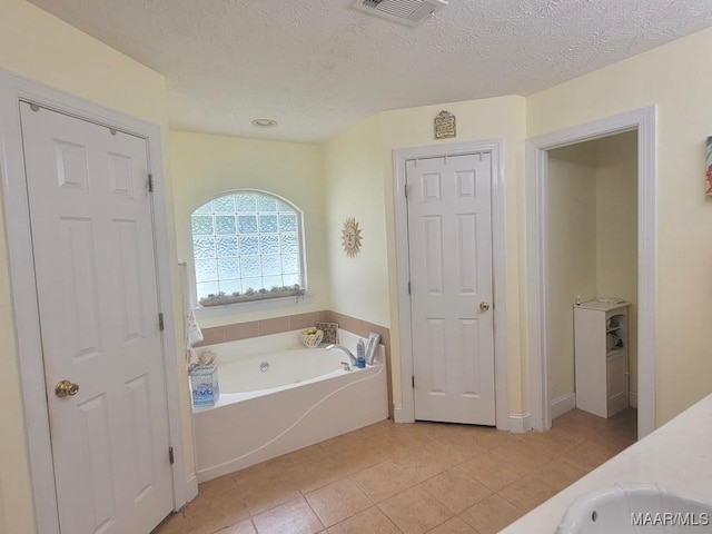 40 Larkspur Ln, Millbrook, AL 36054 - bathroom with a garden tub, tile patterned floors, a textured ceiling, and vanity