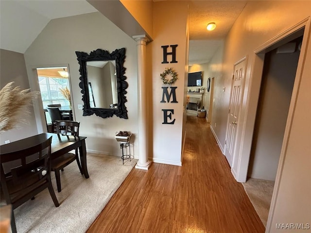 3701 Claiborne Cir, Montgomery, AL 36116 - hallway featuring wood finished floors, lofted ceiling, baseboards, and decorative columns