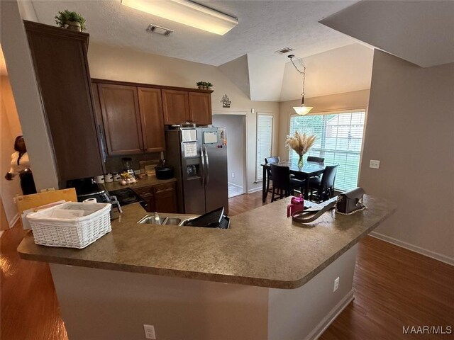 3701 Claiborne Cir, Montgomery, AL 36116 - kitchen featuring stainless steel refrigerator with ice dispenser, a peninsula, baseboards, dark wood finished floors, and lofted ceiling