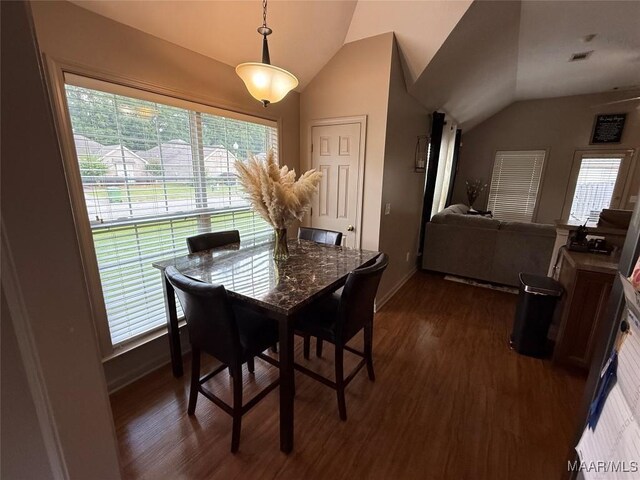 3701 Claiborne Cir, Montgomery, AL 36116 - dining area with vaulted ceiling, dark wood-style flooring, healthy amount of natural light, and baseboards