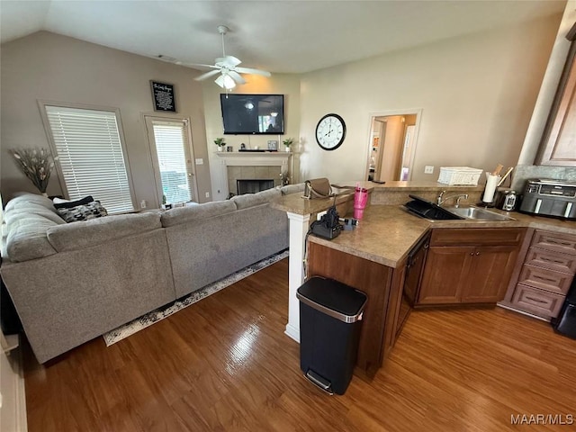 3701 Claiborne Cir, Montgomery, AL 36116 - living room featuring wood finished floors, a fireplace, a ceiling fan, and vaulted ceiling
