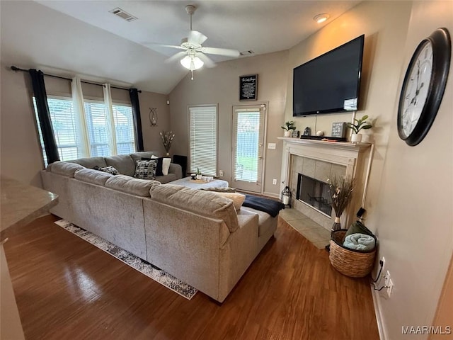 3701 Claiborne Cir, Montgomery, AL 36116 - living area featuring wood finished floors, a ceiling fan, lofted ceiling, a tile fireplace, and baseboards