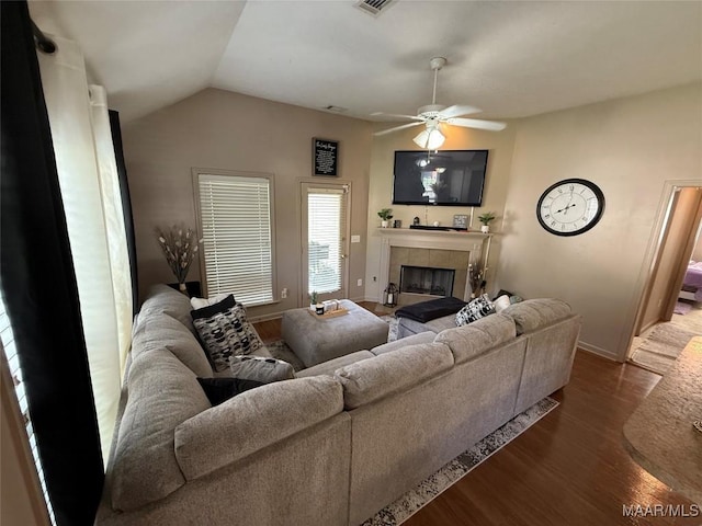 3701 Claiborne Cir, Montgomery, AL 36116 - living room with a tile fireplace, dark wood-type flooring, baseboards, ceiling fan, and lofted ceiling