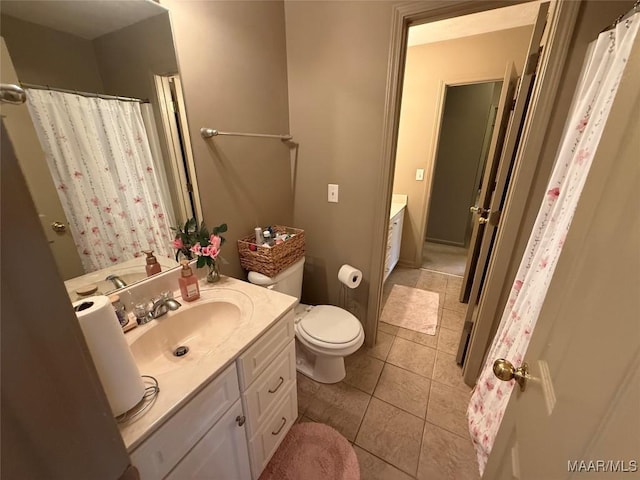 3701 Claiborne Cir, Montgomery, AL 36116 - bathroom featuring vanity, toilet, tile patterned floors, and a shower with curtain